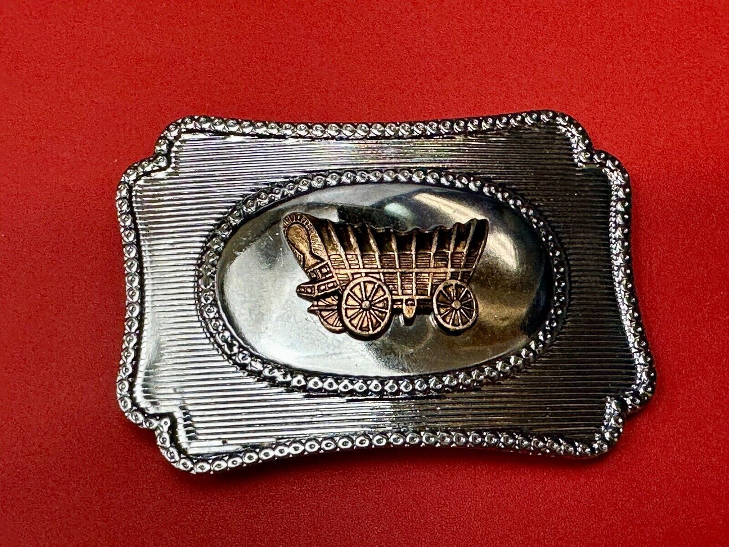 Vintage covered wagon western horse drawn transportation belt buckle