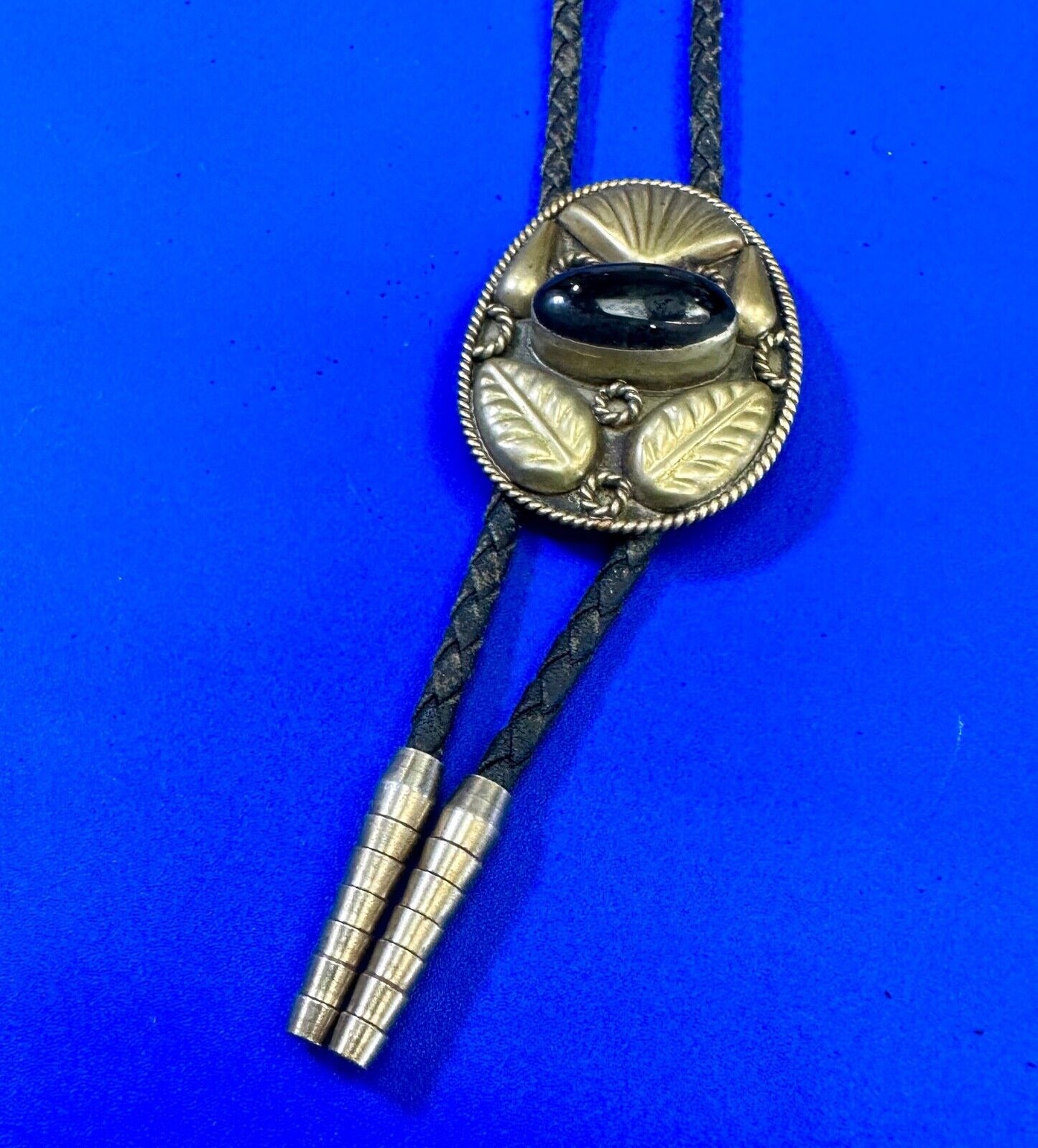 Beautiful Alpaca Mexico bolo tie with dimensional raised leaf's black stone