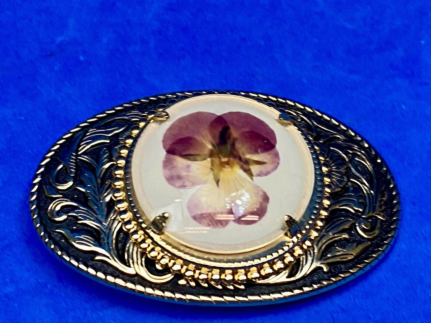 Beautiful pressed purple Violet flower as centerpiece in western belt buckle