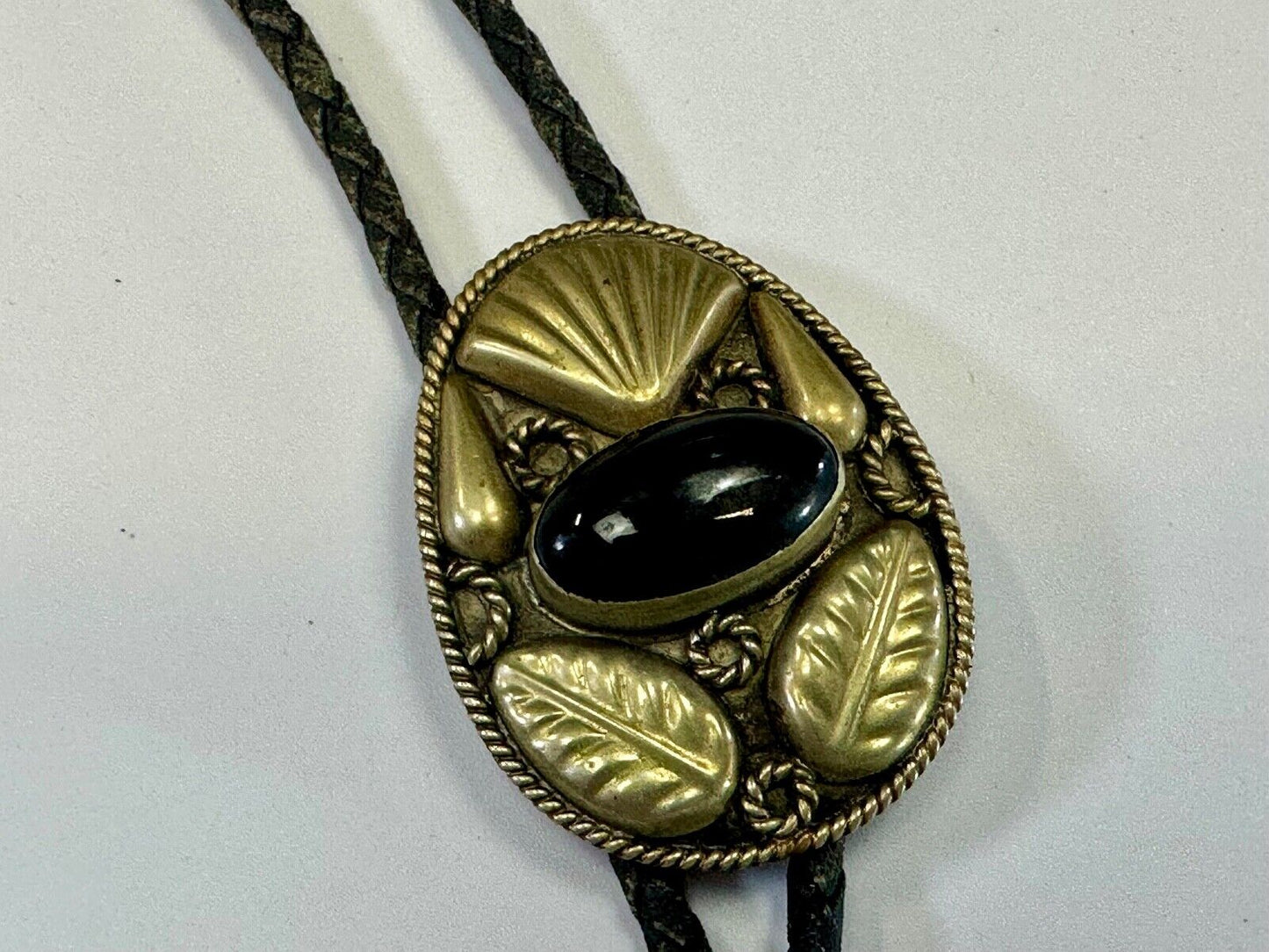 Beautiful Alpaca Mexico bolo tie with dimensional raised leaf's black stone