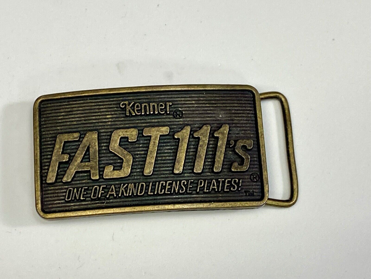 1982 Kenner Fast 111'S Company Advertisement Belt Buckle License Plates