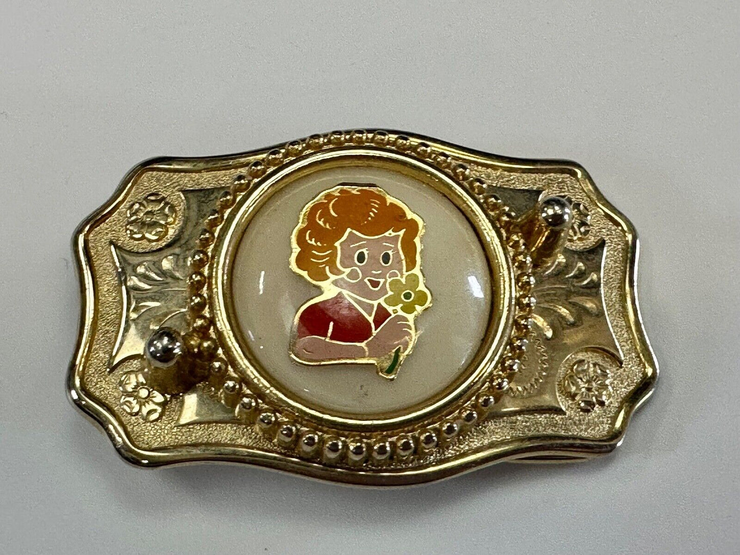 Adorable red headed girl with flower as centerpiece on western belt buckle