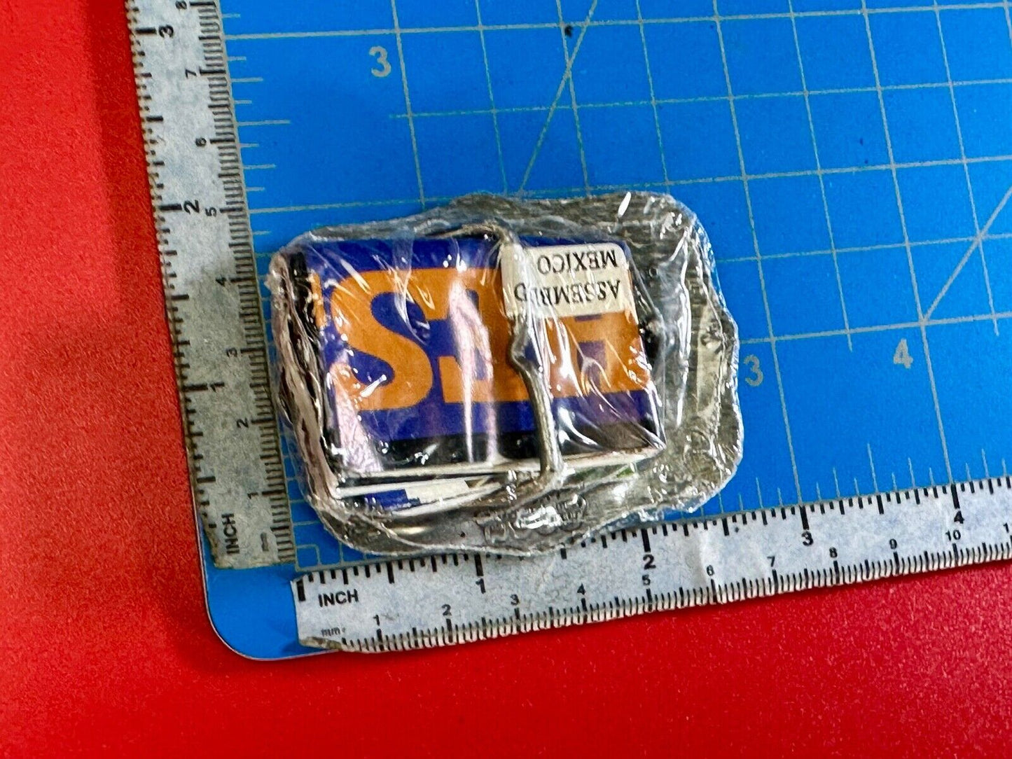 1999 Youth Sized Hesston National Finals Rodeo 2000 series belt buckle in wrap