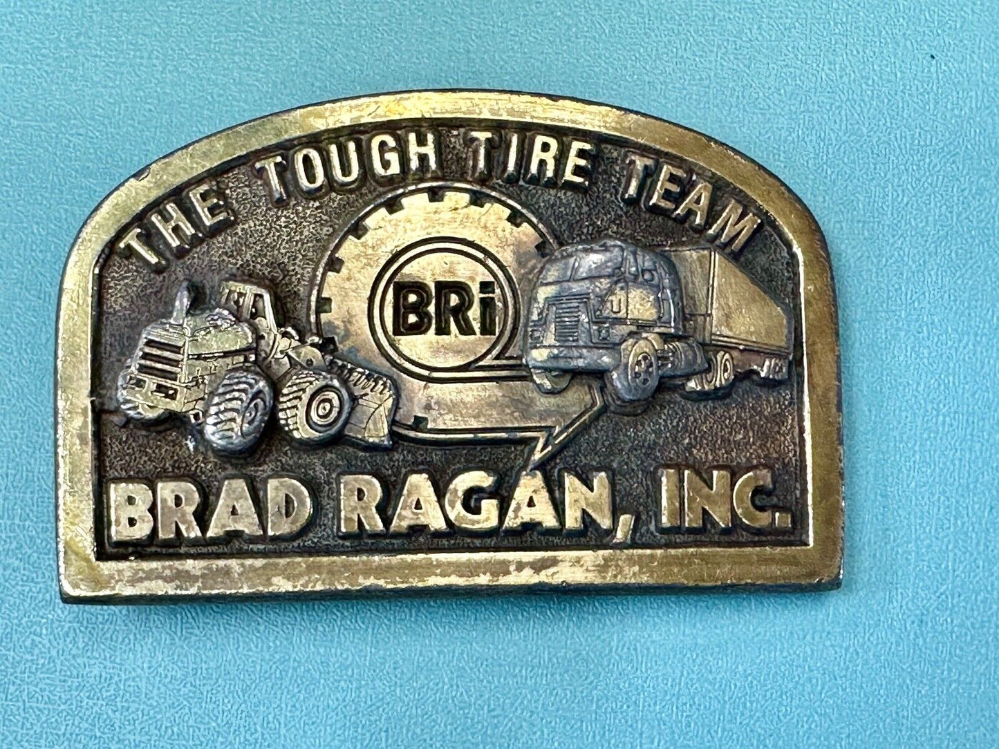 The Tough Tire Team BRi Brad Ragan, Inc. vintage belt buckle by Spec-Cast