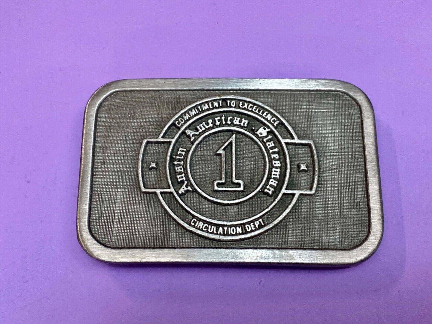 Asian American Circulation Dept Commitment to excellence belt buckle hit-line