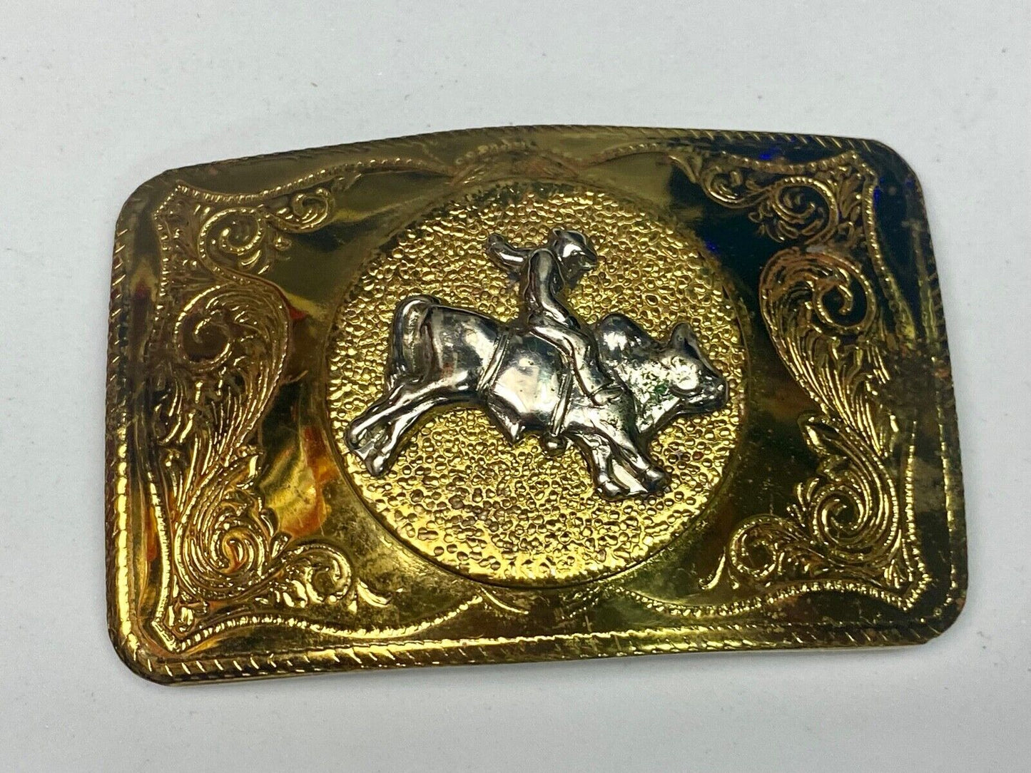 Beautiful ornate solid brass rodeo cowboy on rectangular western belt buckle