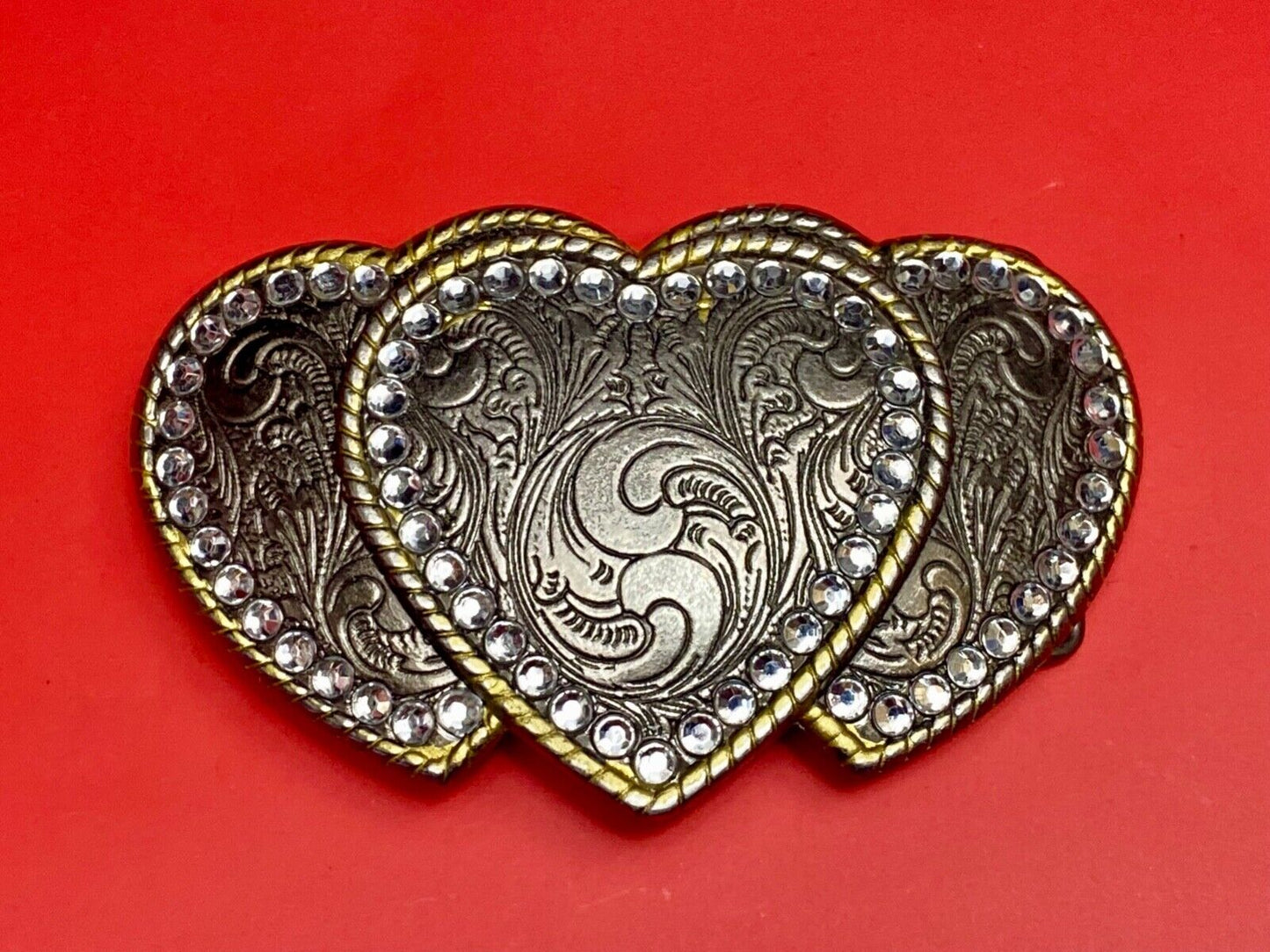 Three hearts ornate flower swirl belt buckle with thick rhinestone boarder