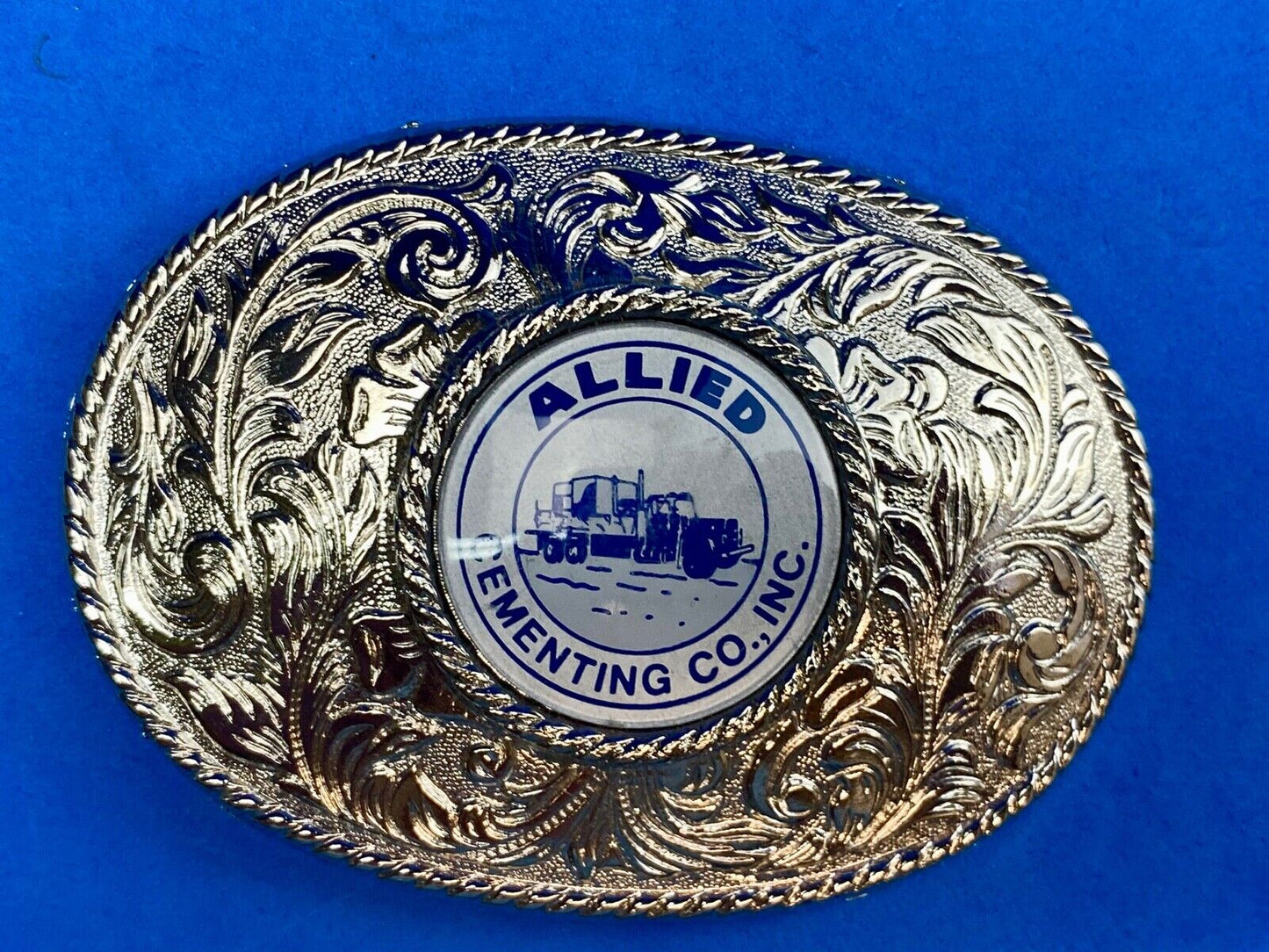 Beautiful belt buckle with centerpiece picture of Allied Cementing Company