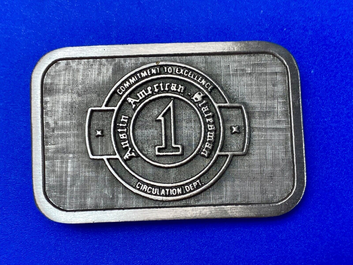 Asian American Circulation Dept Commitment to excellence belt buckle hit-line