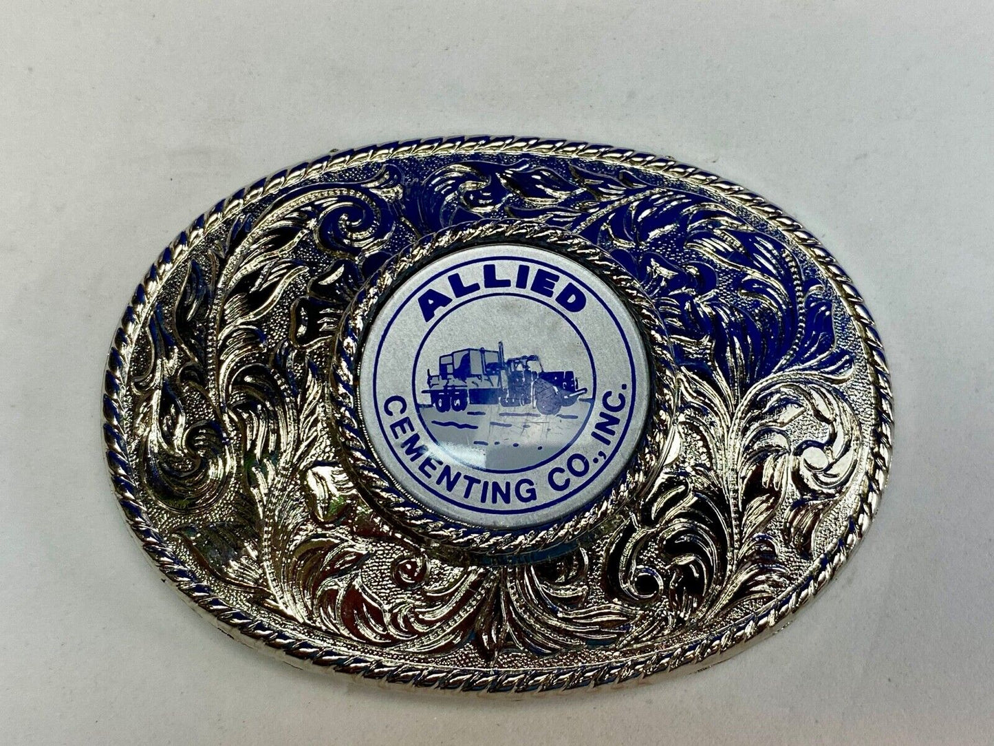Beautiful belt buckle with centerpiece picture of Allied Cementing Company