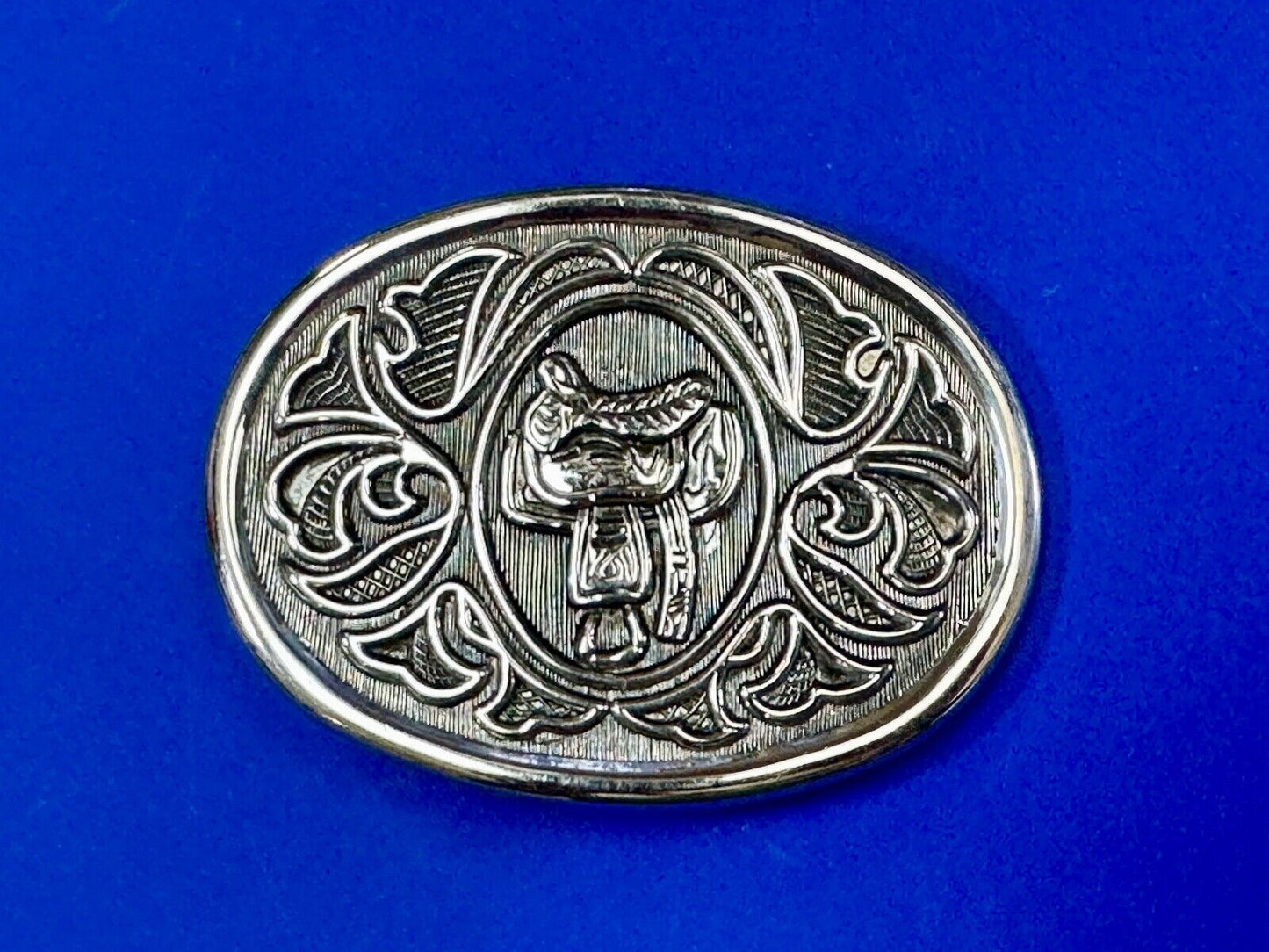 Vintage Cowboy's Horse Saddle ornate flower swirl oval belt buckle by Avon