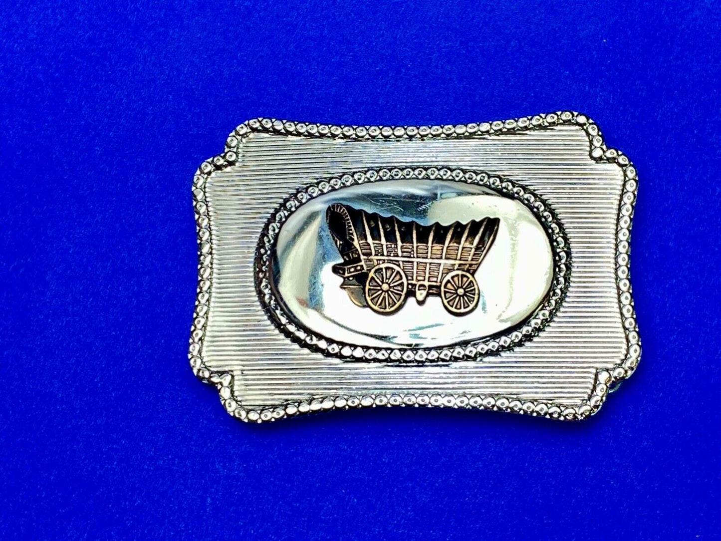 Vintage Covered wagon two tone reflective pre loved, western framed belt buckle