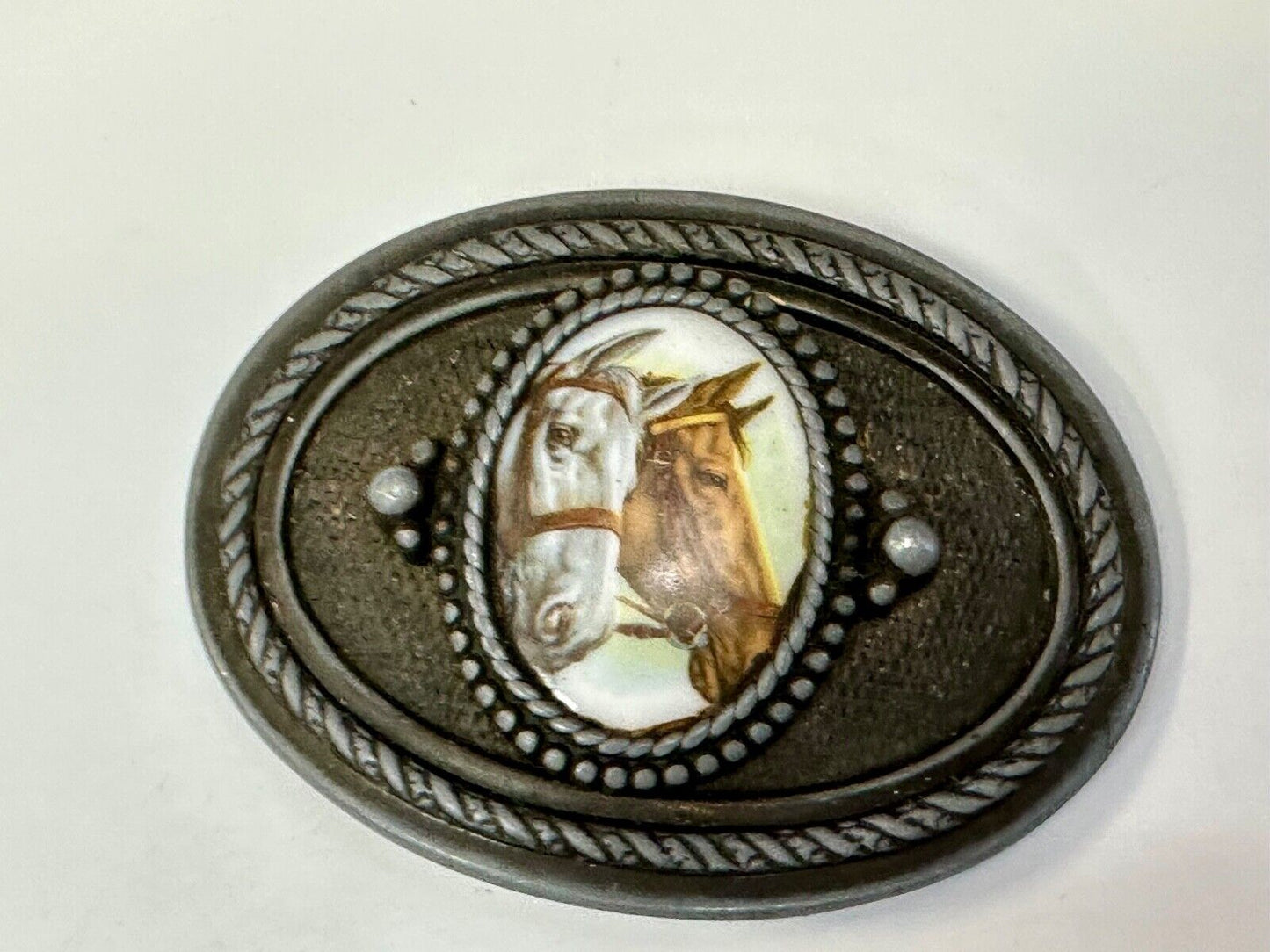 2 horses picture as centerpiece in western oval belt buckle with rope border