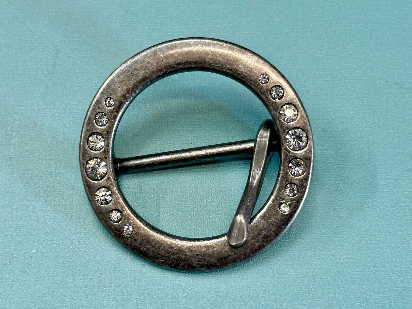 2" Round silver tone belt buckle with graduated rhinestone sized