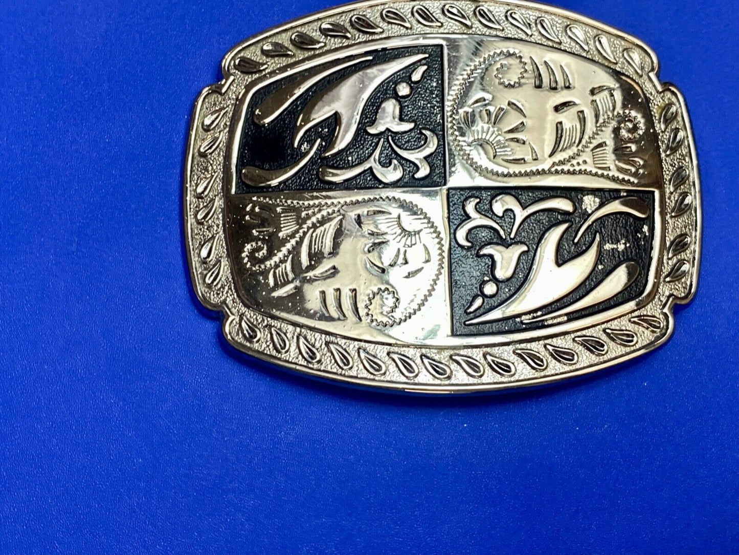black and silver color western flower swirl outlined cowboy's belt buckle