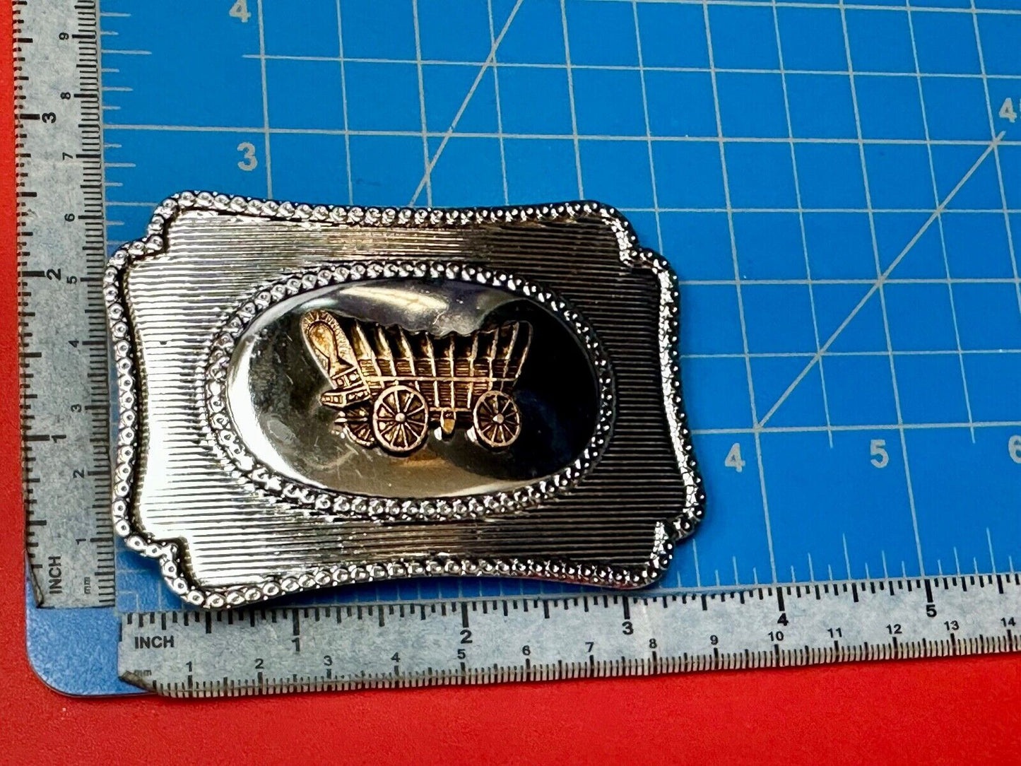 Vintage covered wagon western horse drawn transportation belt buckle
