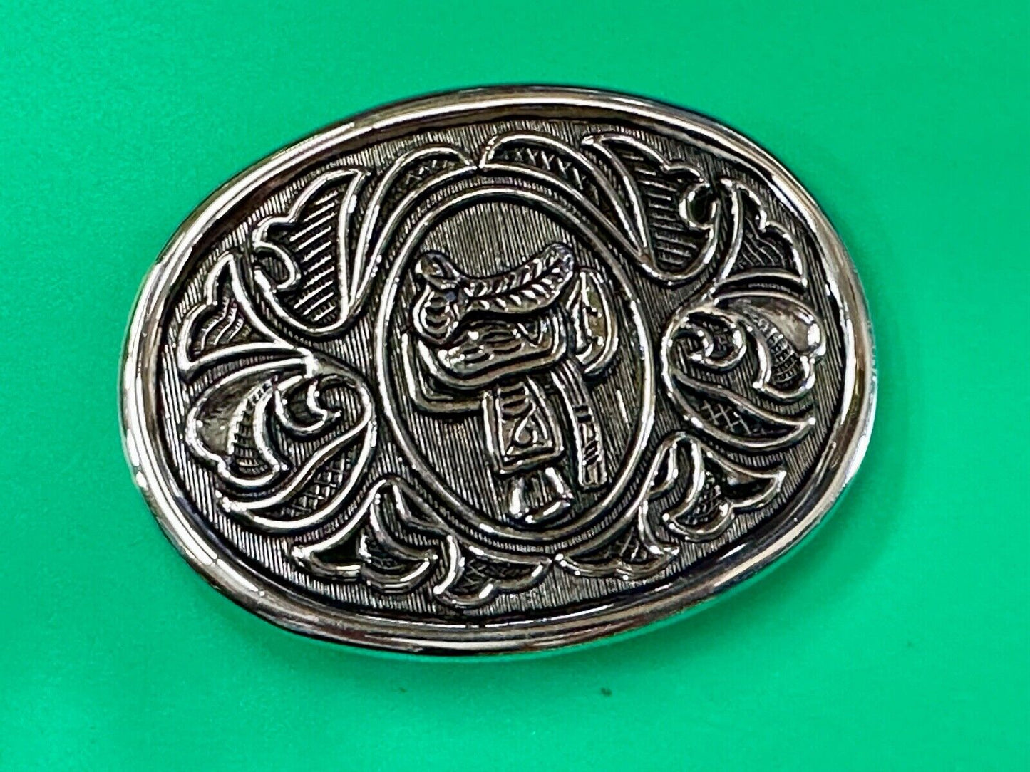 Vintage Cowboy's Horse Saddle ornate flower swirl oval belt buckle by Avon