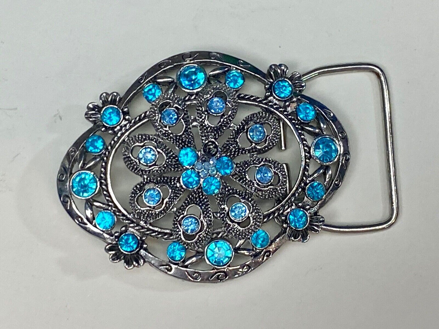 BEAUTIFUL BLUE rhinestones mounted in oval shaped flower theme belt buckle
