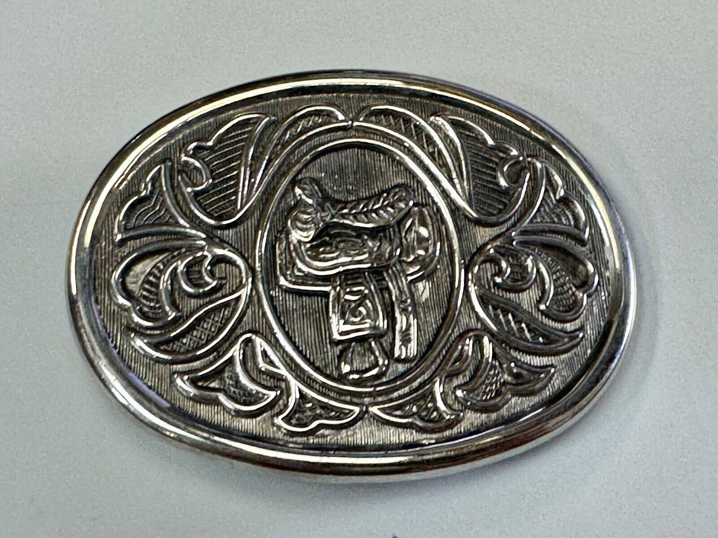 Vintage Cowboy's Horse Saddle ornate flower swirl oval belt buckle by Avon