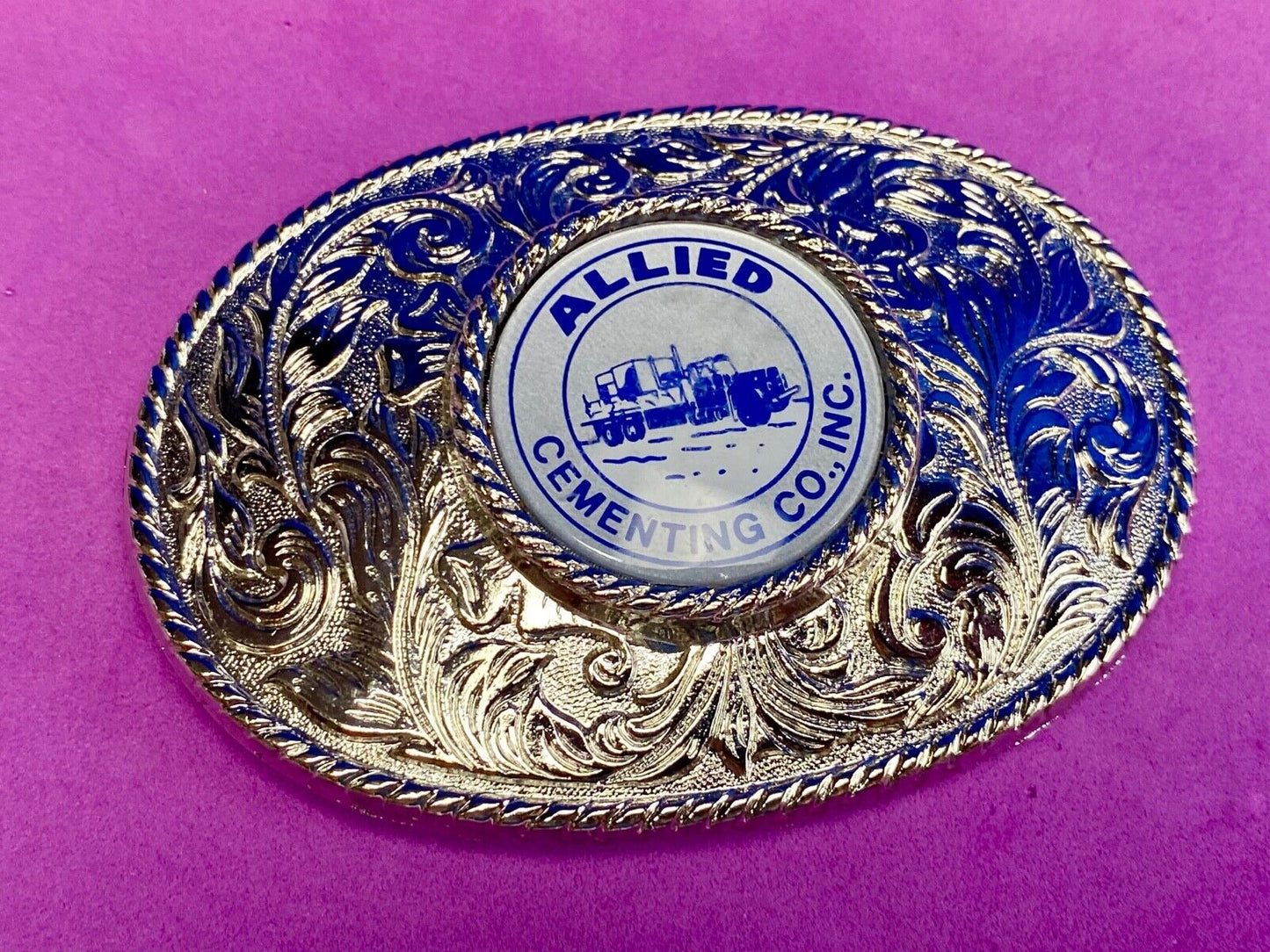 Beautiful belt buckle with centerpiece picture of Allied Cementing Company