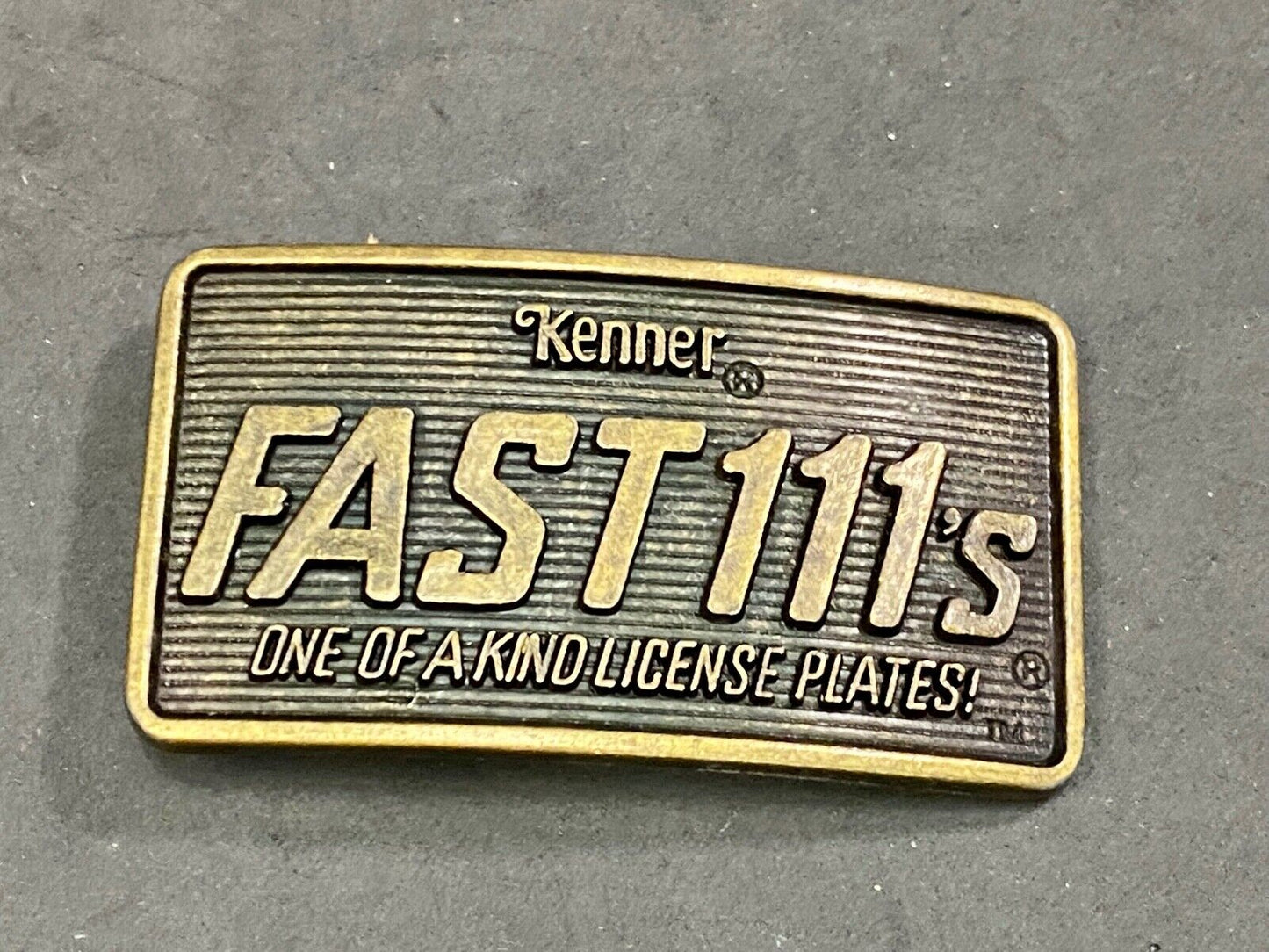 1982 Kenner Fast 111'S Company Advertisement Belt Buckle License Plates