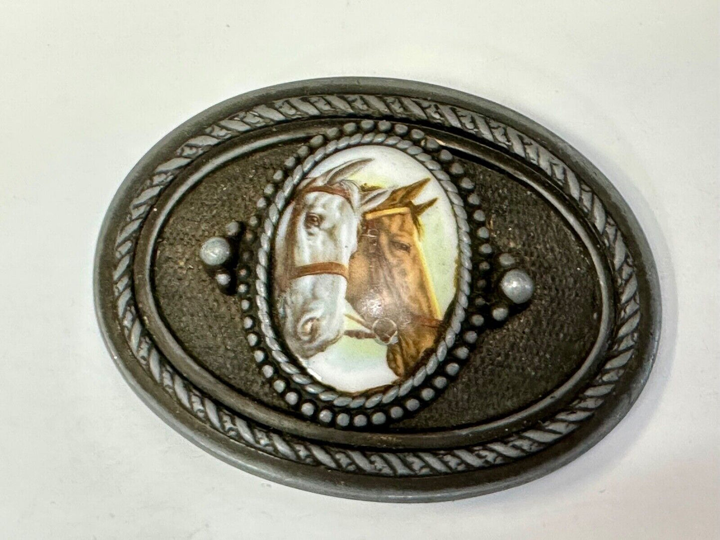 2 horses picture as centerpiece in western oval belt buckle with rope border