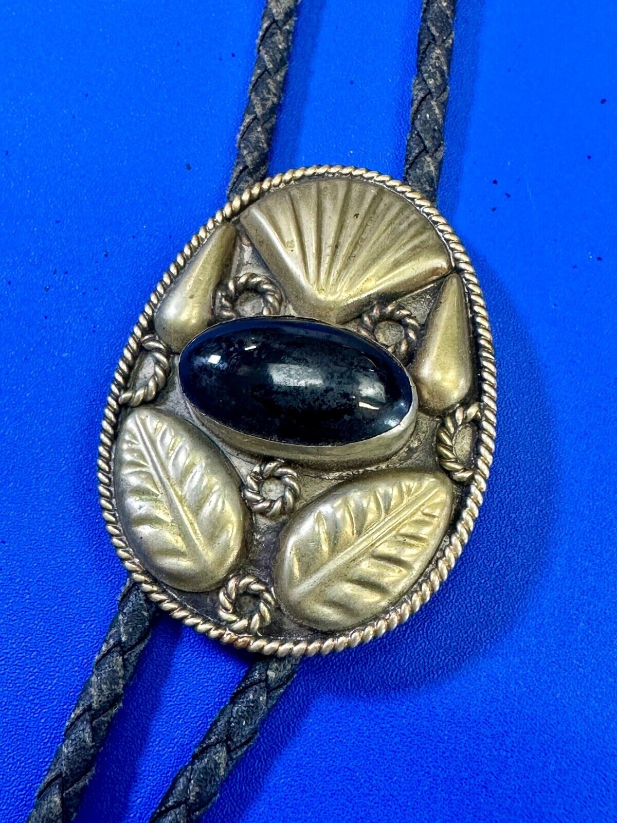 Beautiful Alpaca Mexico bolo tie with dimensional raised leaf's black stone