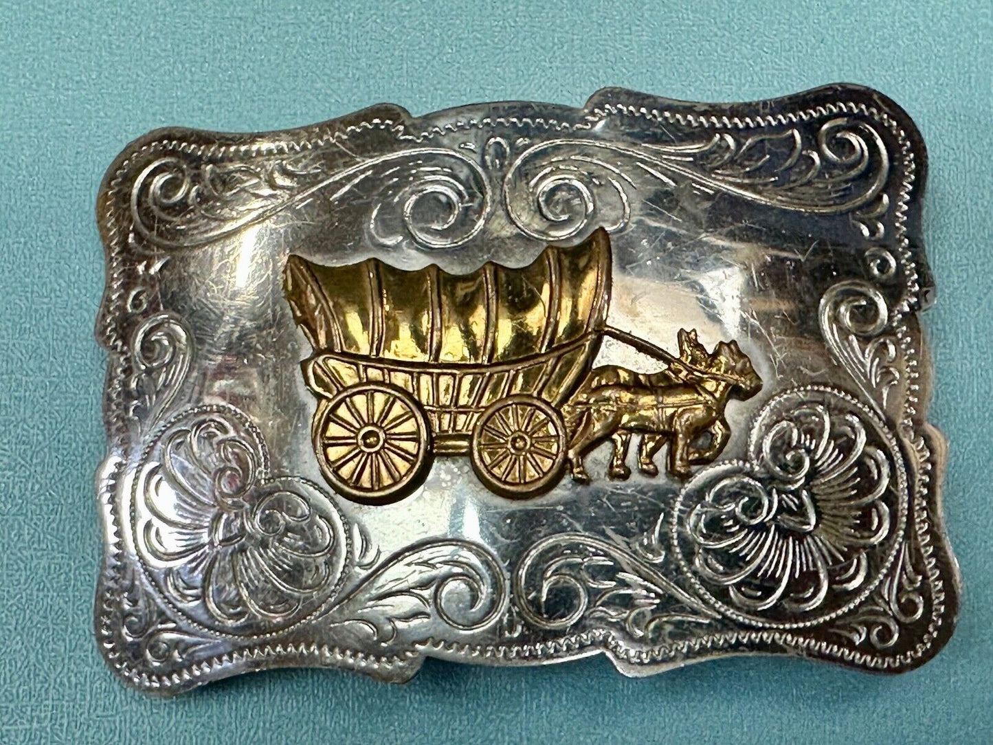 Vintage Covered Wagon two tone ornate cowboys out west flower swirl belt buckle