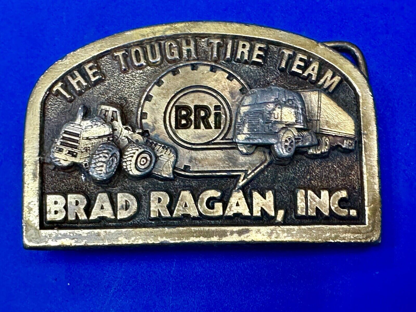 The Tough Tire Team BRi Brad Ragan, Inc. vintage belt buckle by Spec-Cast