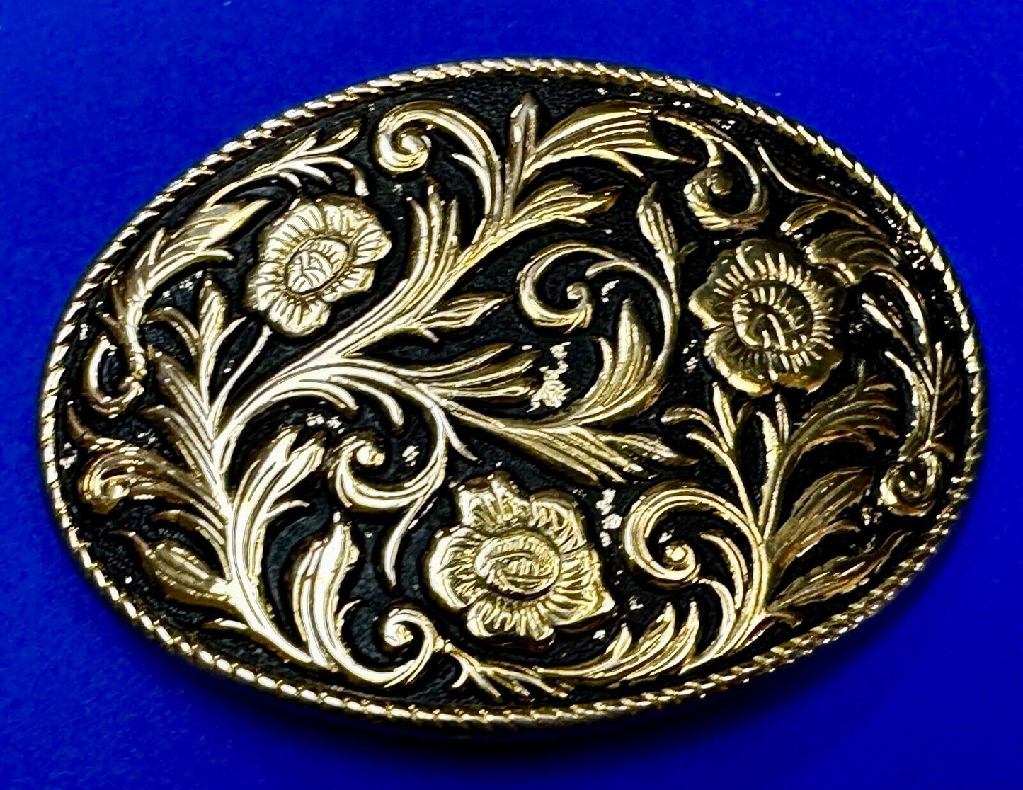 Vintage black and gold tone western flower floral theme cowboys belt buckle