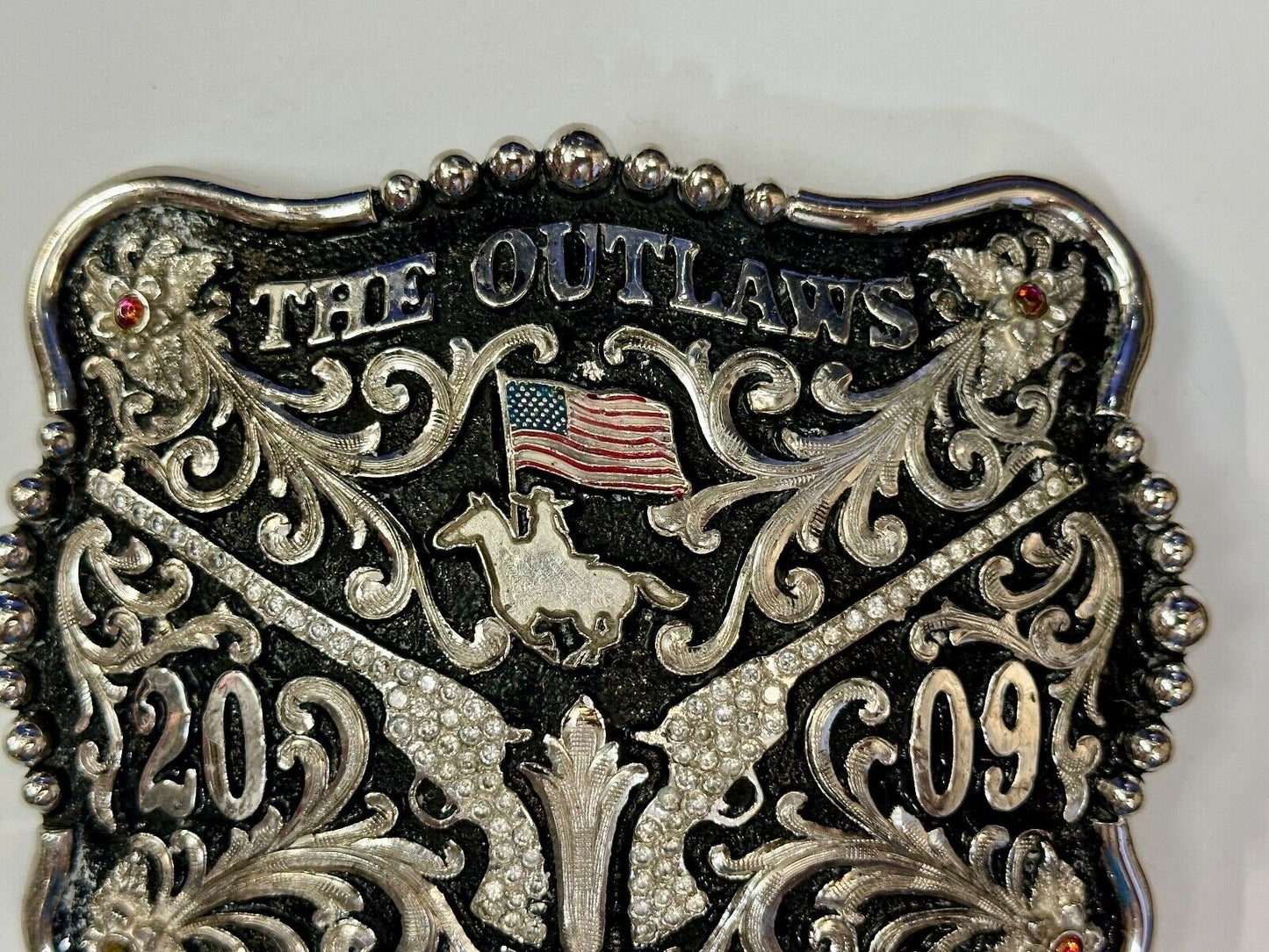 The Outlaws Rodeo Cowboy Trophy 2009 Flag Belt Buckle - Crossroads bucklesTexas