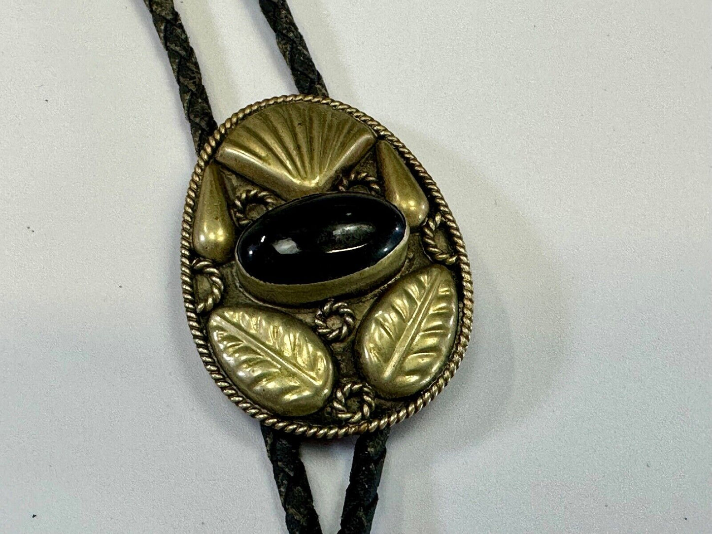 Beautiful Alpaca Mexico bolo tie with dimensional raised leaf's black stone