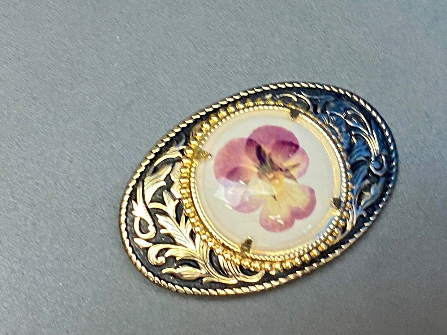 Beautiful pressed purple Violet flower as centerpiece in western belt buckle