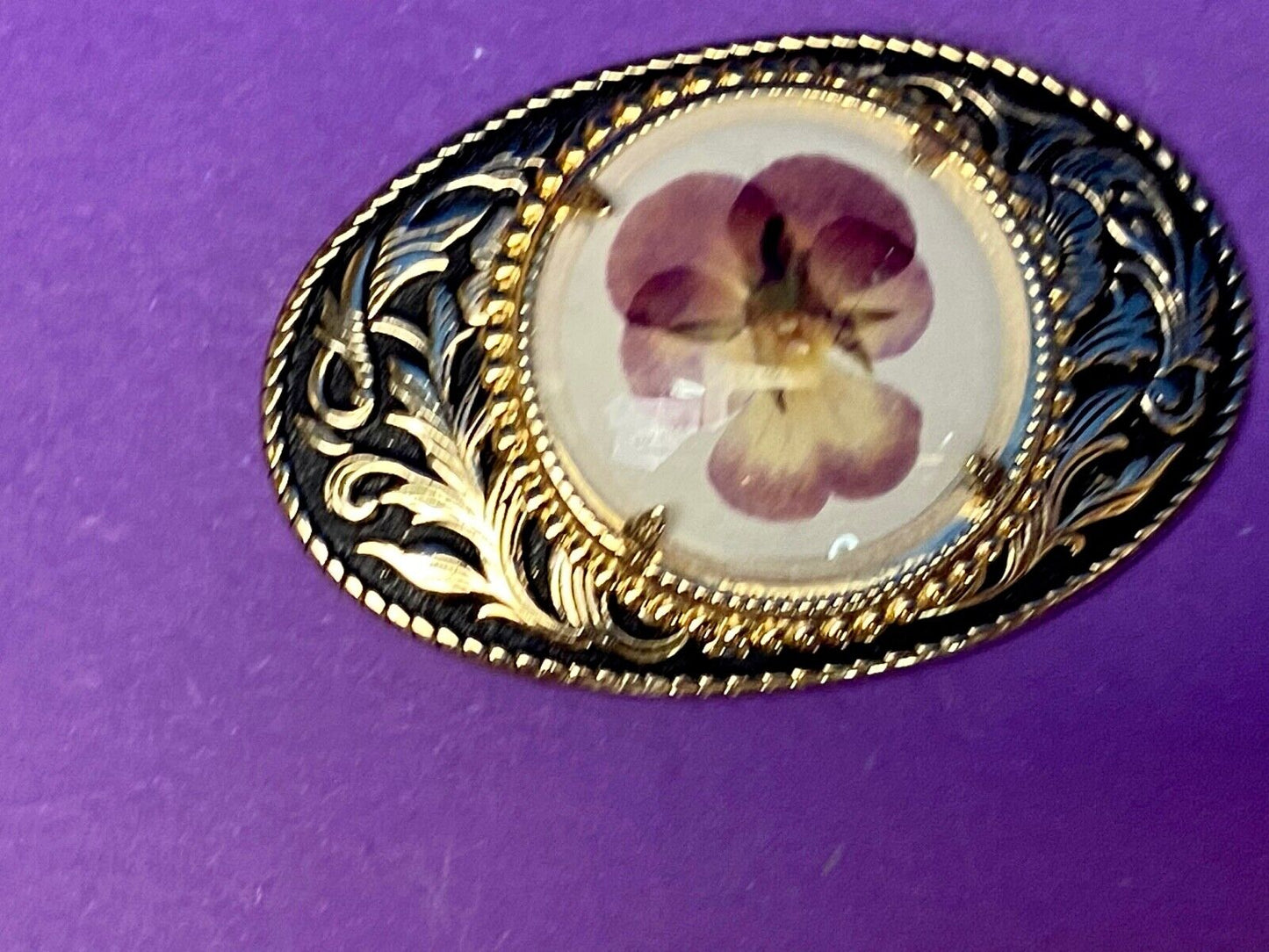 Beautiful pressed purple Violet flower as centerpiece in western belt buckle