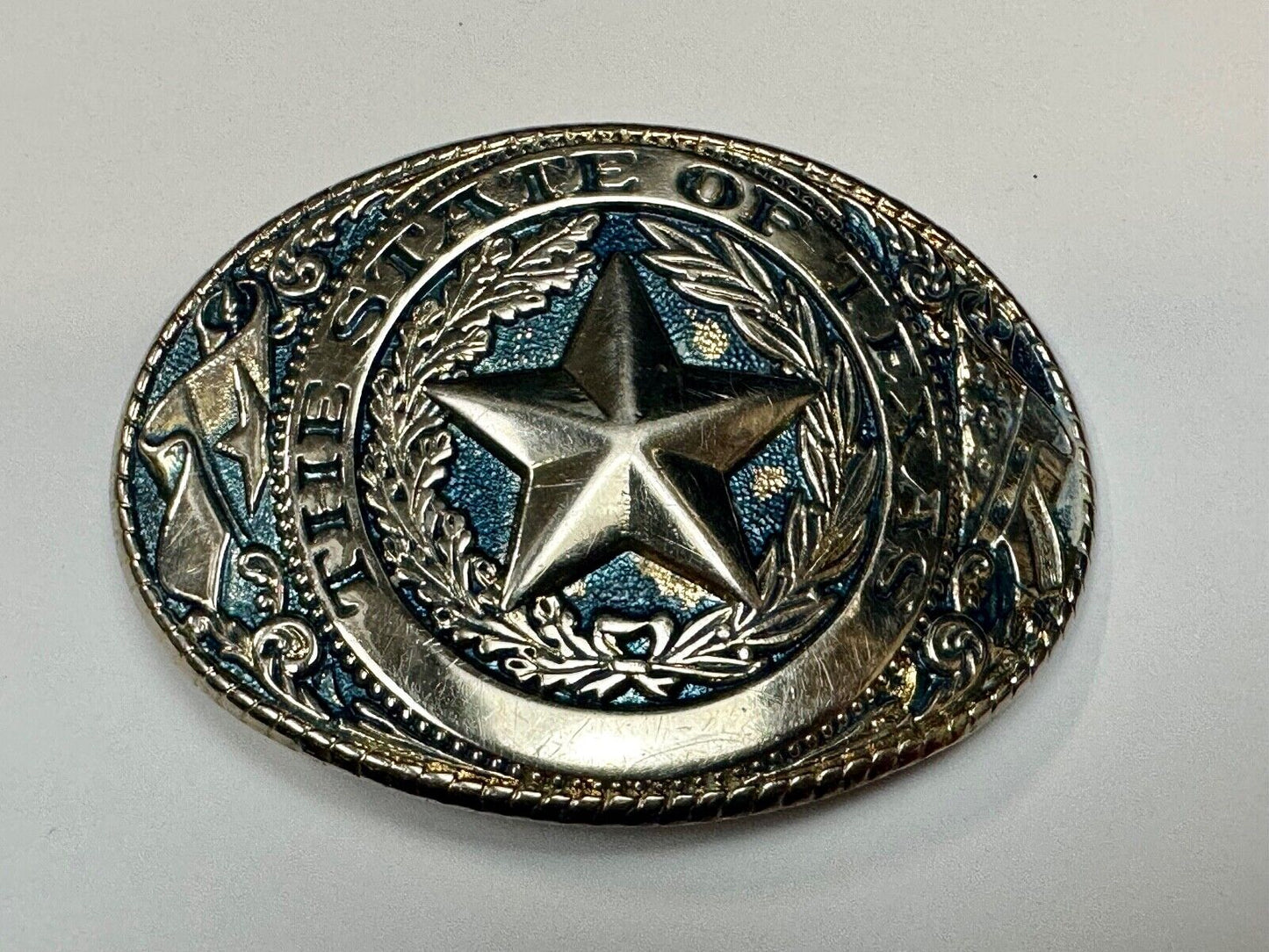 The Great State of Texas - gold color star belt buckle with blue colored accents
