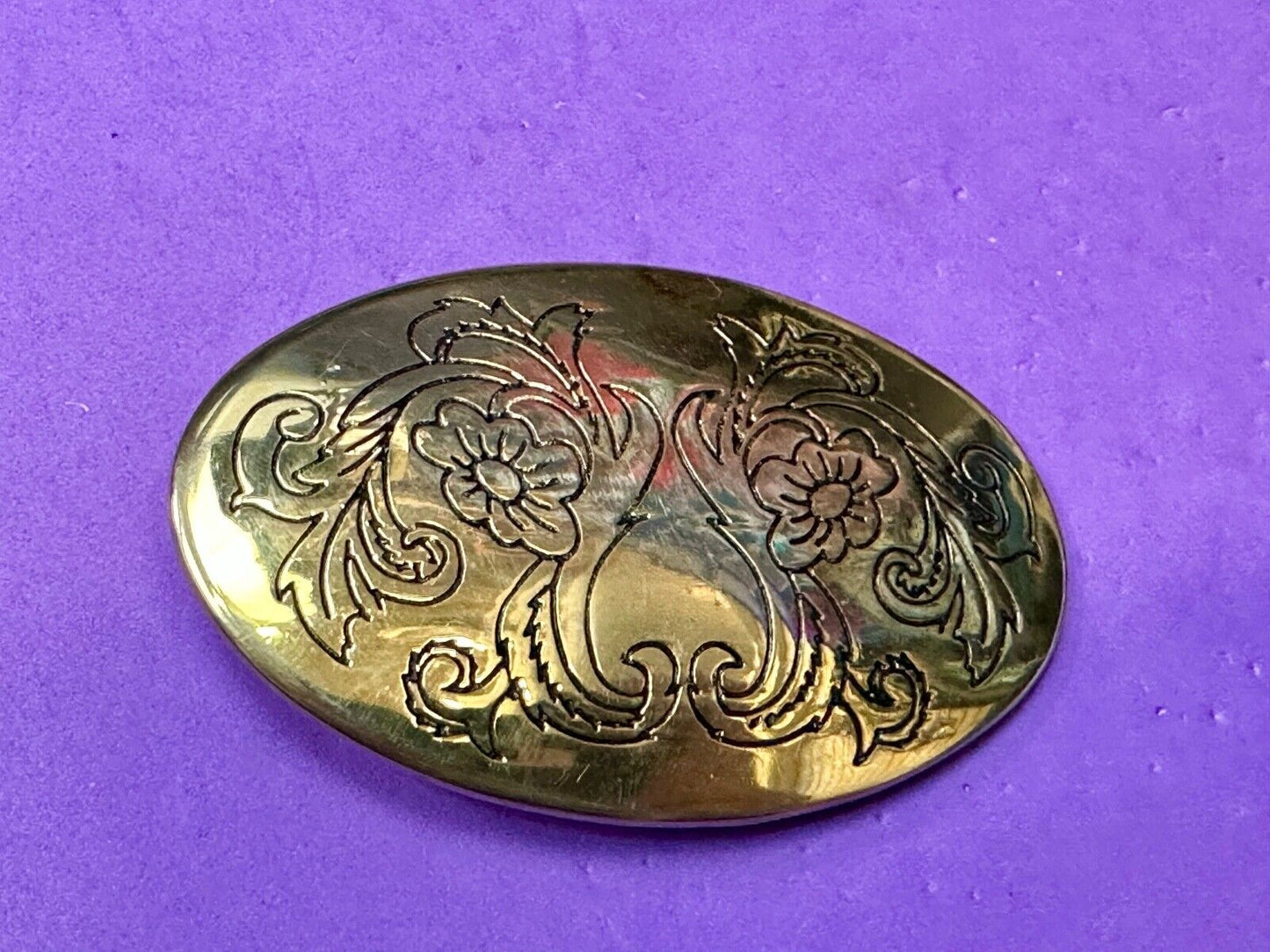 Antique? Engraved flower swirl pattern on gold color oval belt buckle