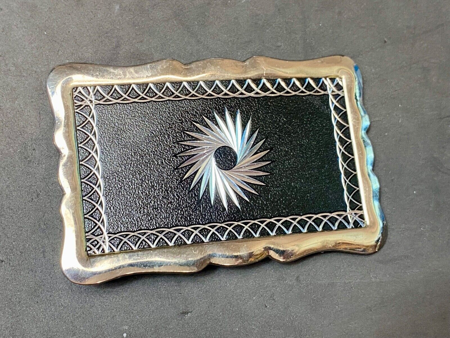 Black and silver color etched starburst pattern rectangular belt buckle
