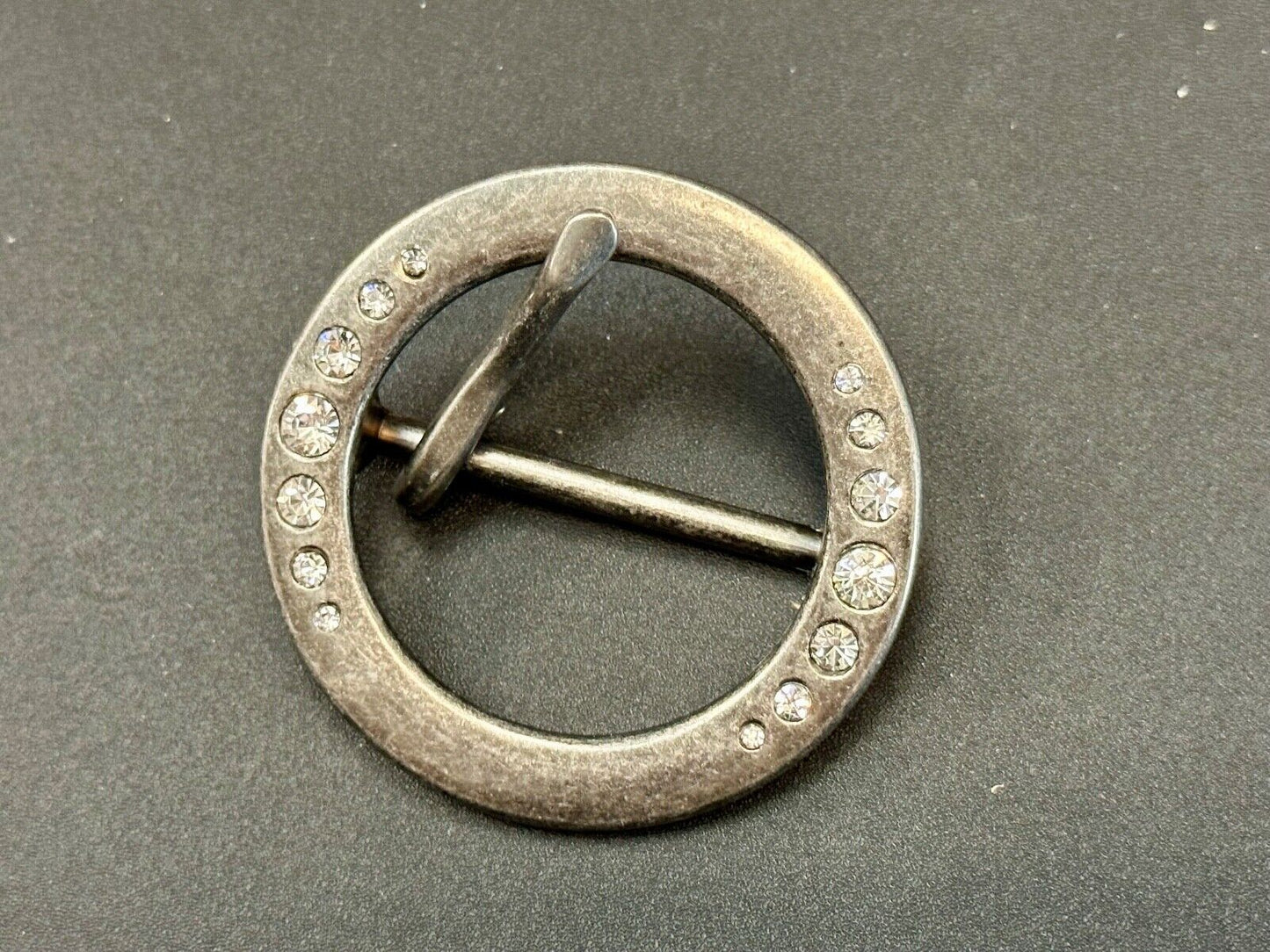 2" Round silver tone belt buckle with graduated rhinestone sized