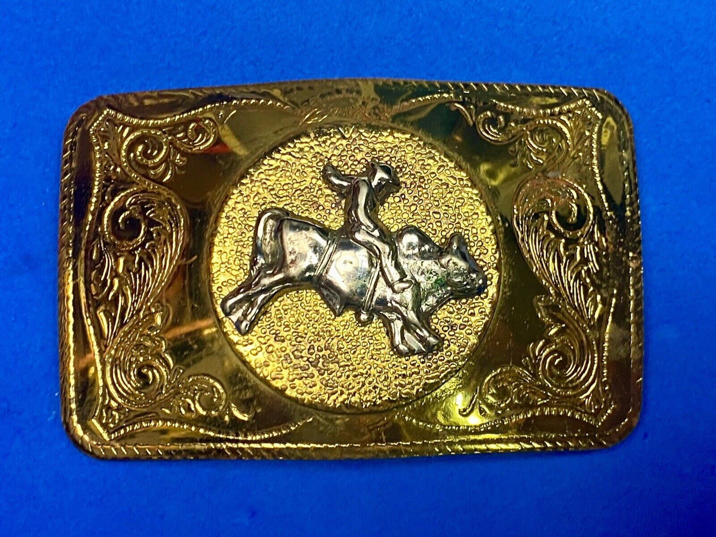 Beautiful ornate solid brass rodeo cowboy on rectangular western belt buckle