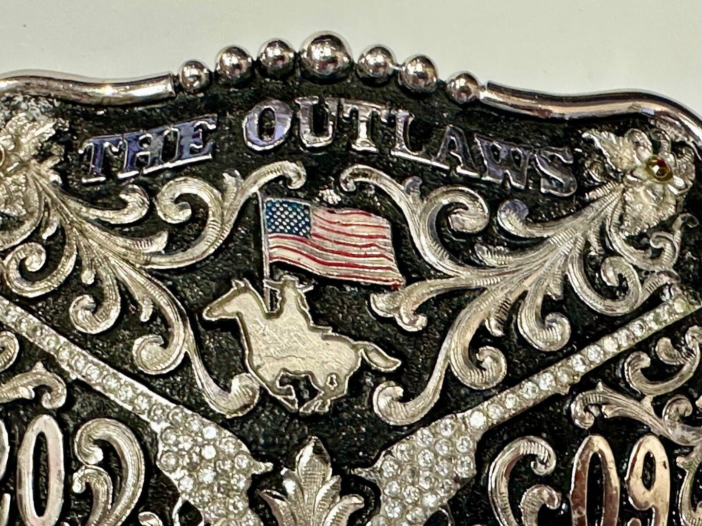 The Outlaws Rodeo Cowboy Trophy 2009 Flag Belt Buckle - Crossroads bucklesTexas