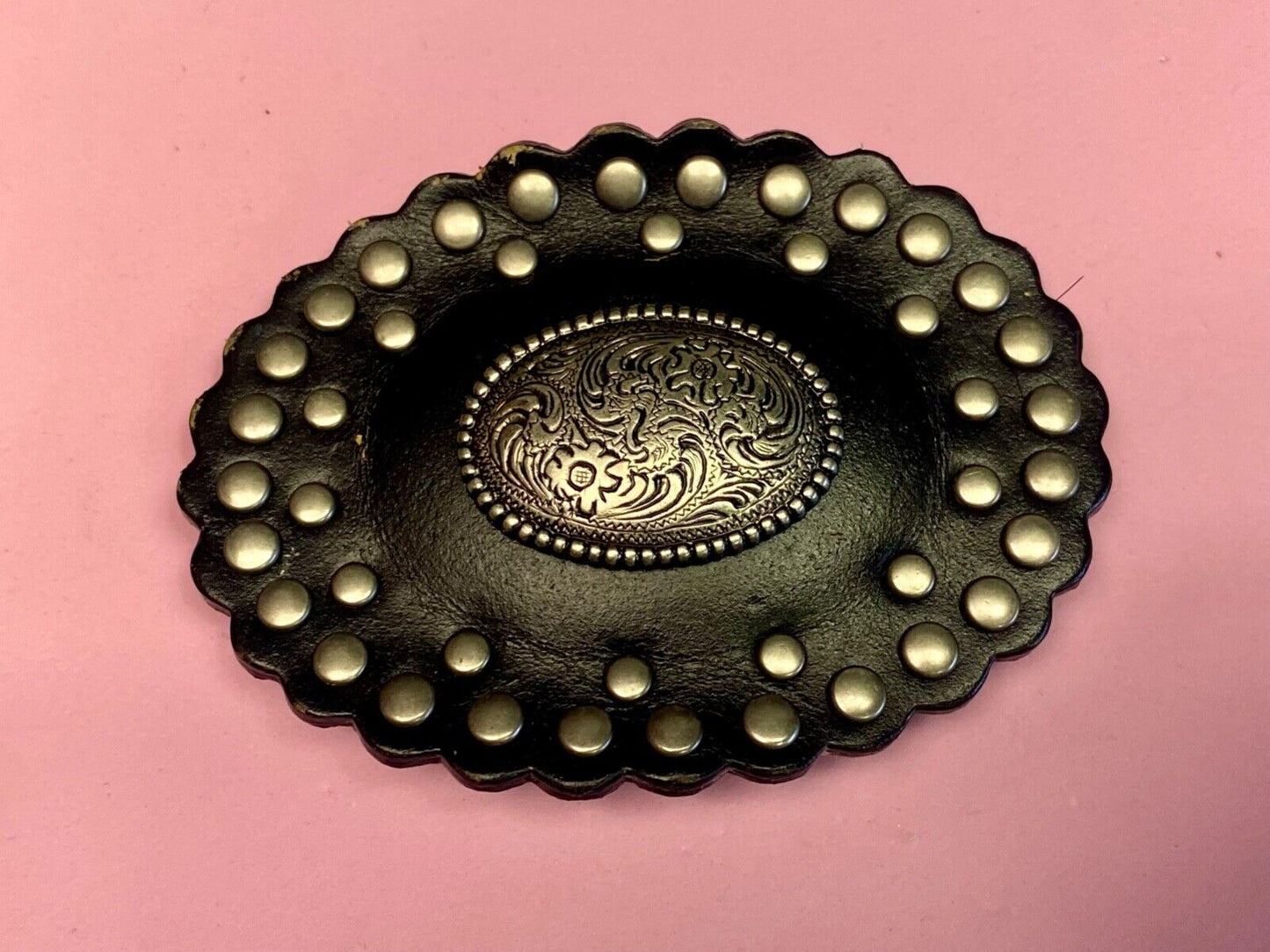 4" wide studded black leather oval belt buckle with flower swirl center