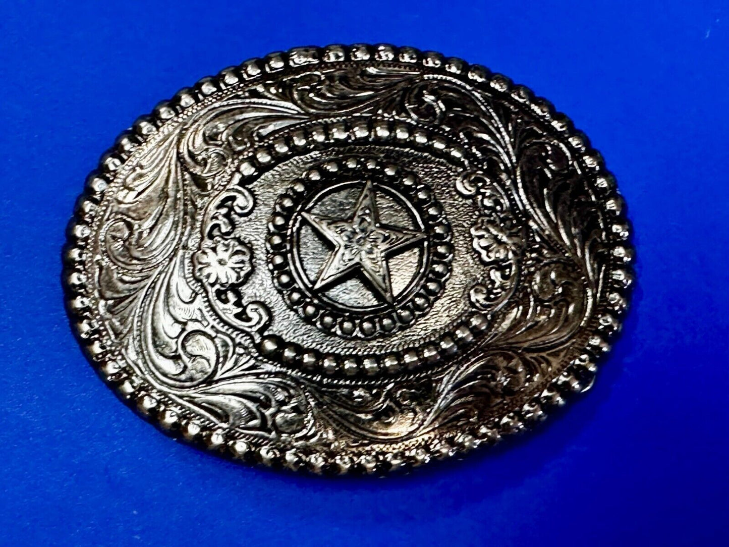 The Lone Star Centered In Oval Flower Swirl Silver Tone Belt Buckle