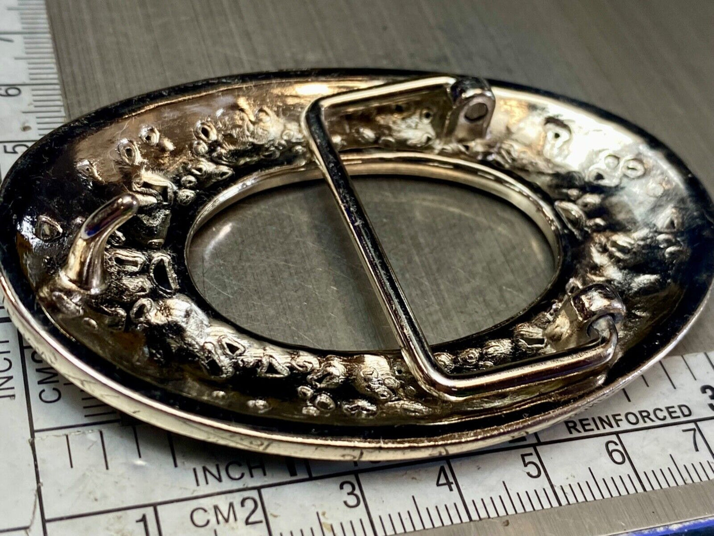 Unique blue rhinestone accented oval see though silver tone belt buckle
