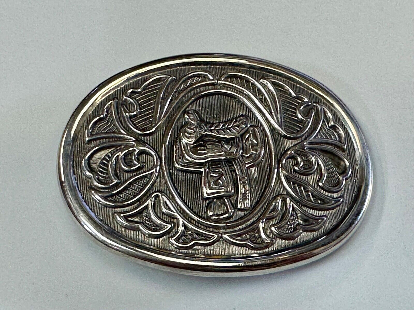 Vintage Cowboy's Horse Saddle ornate flower swirl oval belt buckle by Avon