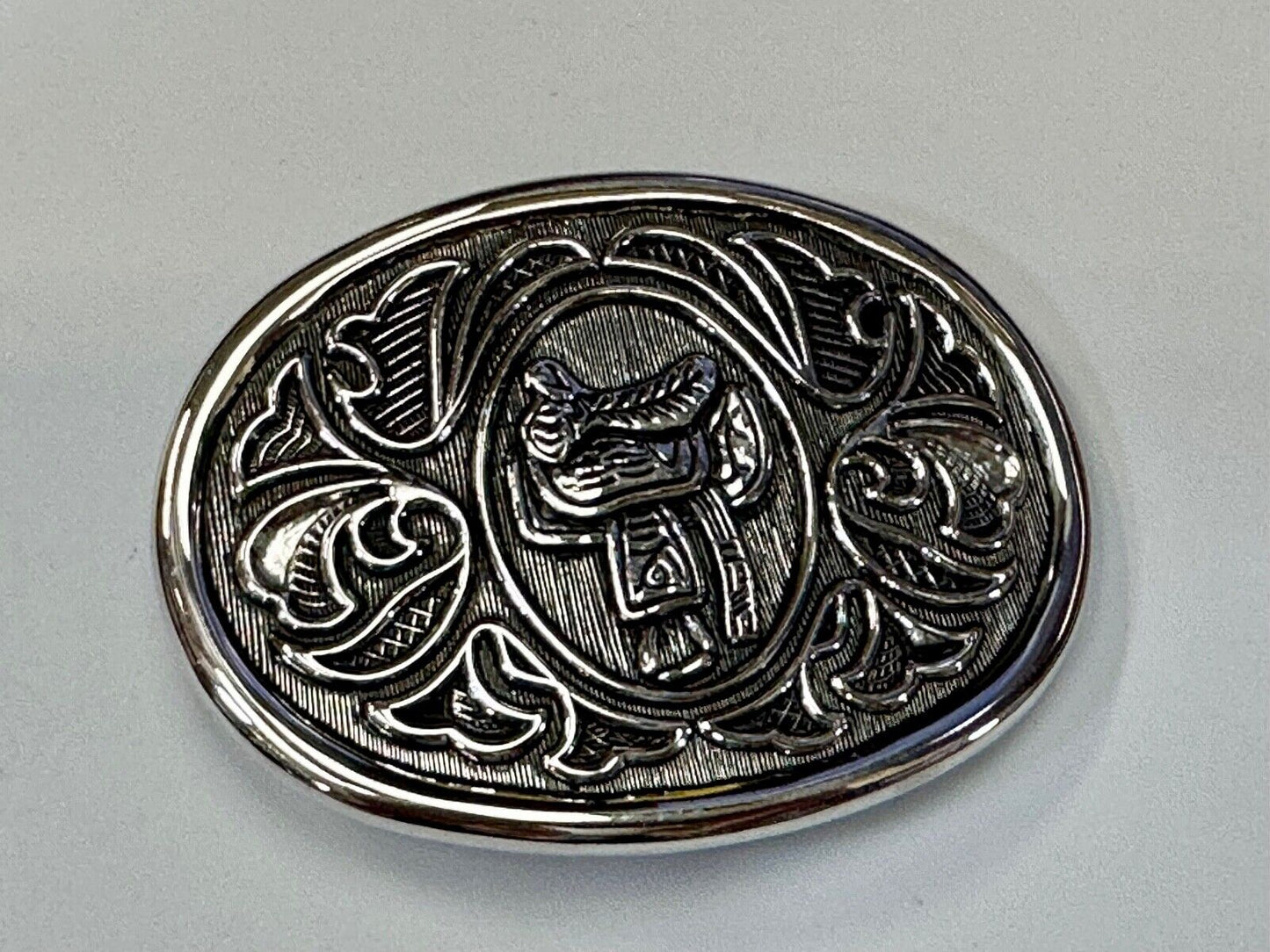 Vintage Cowboy's Horse Saddle ornate flower swirl oval belt buckle by Avon