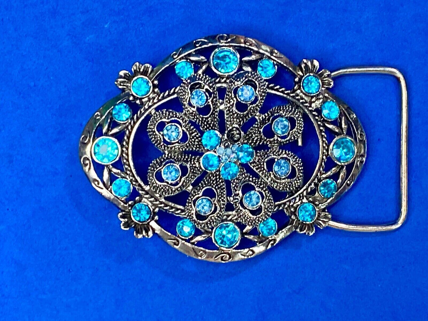 BEAUTIFUL BLUE rhinestones mounted in oval shaped flower theme belt buckle