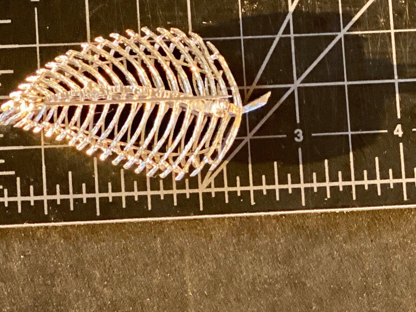 SWP INC signed Gold tone skeleton see through leaf brooch