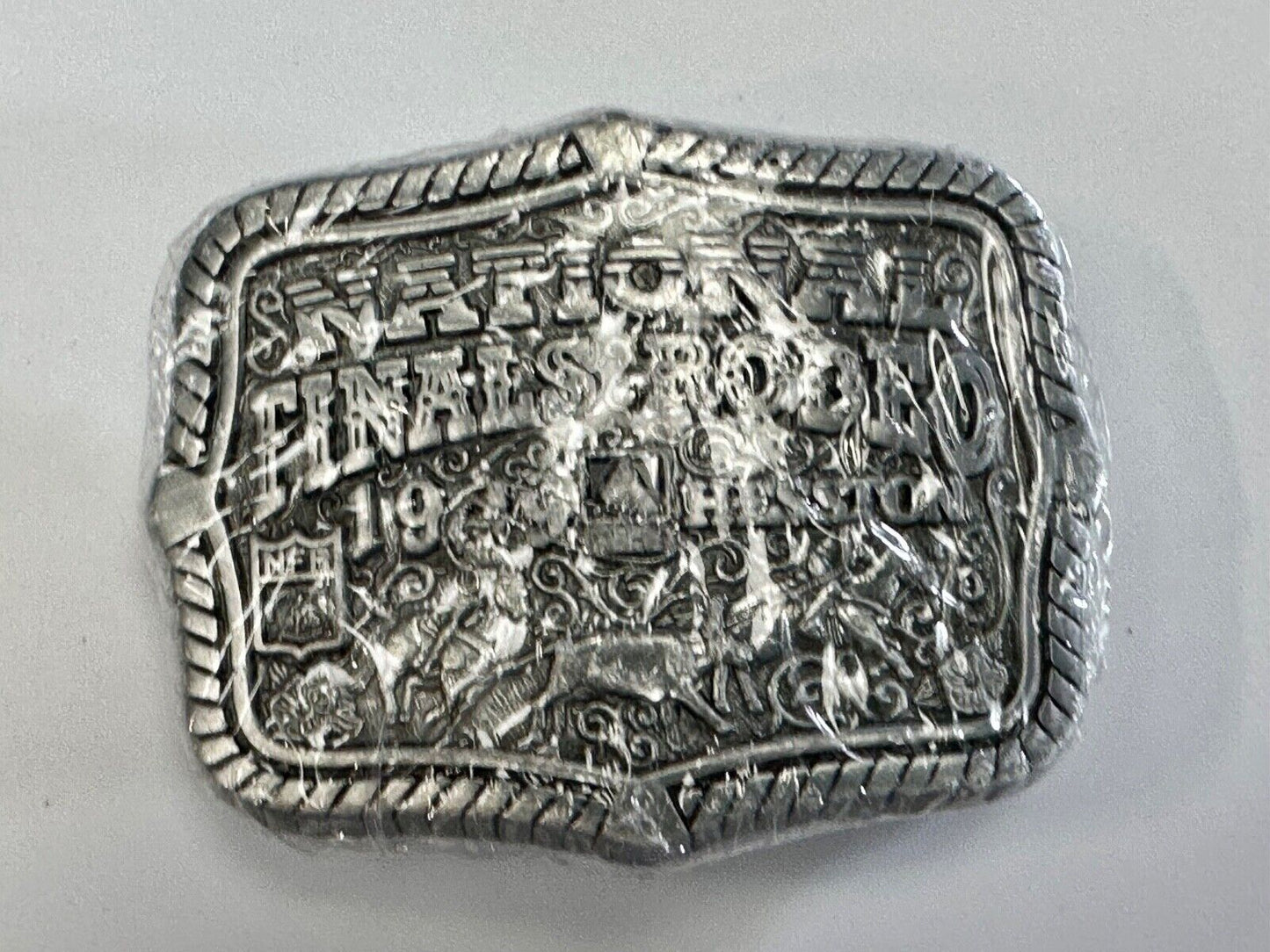 1999 Youth Sized Hesston National Finals Rodeo 2000 series belt buckle in wrap
