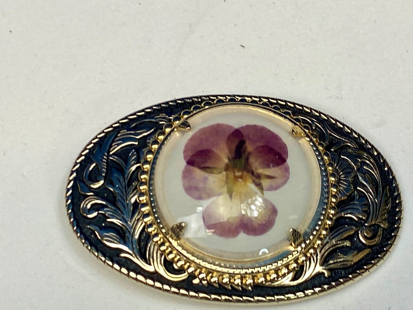 Beautiful pressed purple Violet flower as centerpiece in western belt buckle