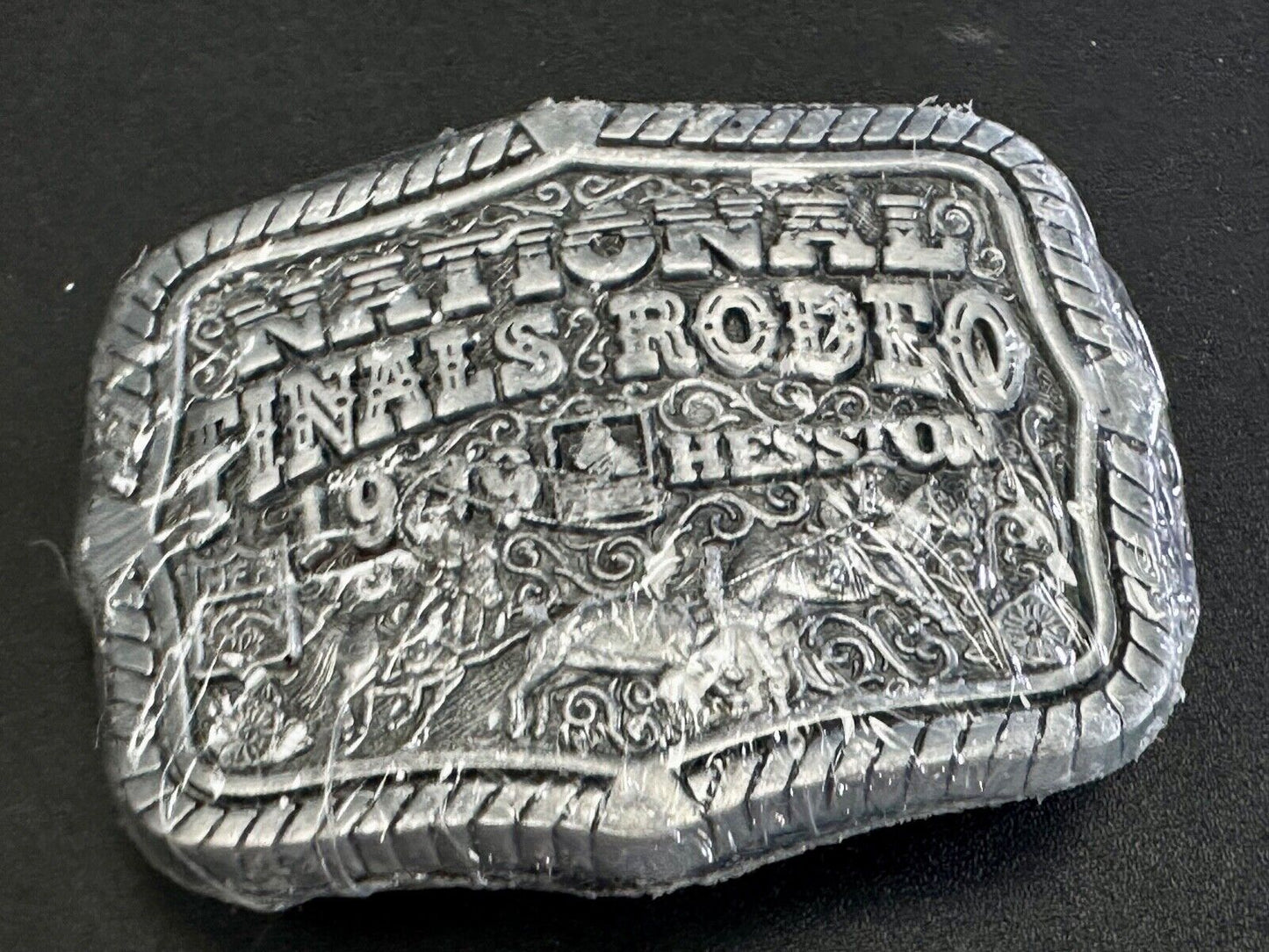 1999 Youth Sized Hesston National Finals Rodeo 2000 series belt buckle in wrap